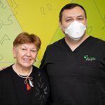 Pacient in stanga, medic stomatolog in dreapta in clinica dentara