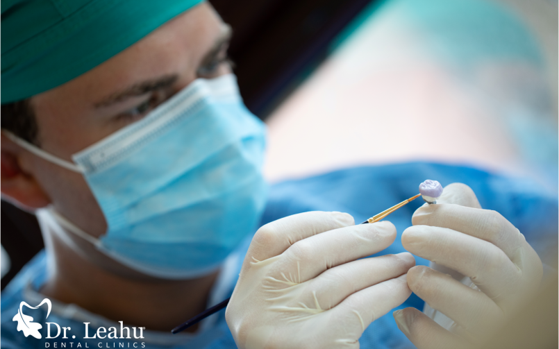 medic stomatolog in timp ce pregateste o coroana dentara pentru insurubarea pe implant